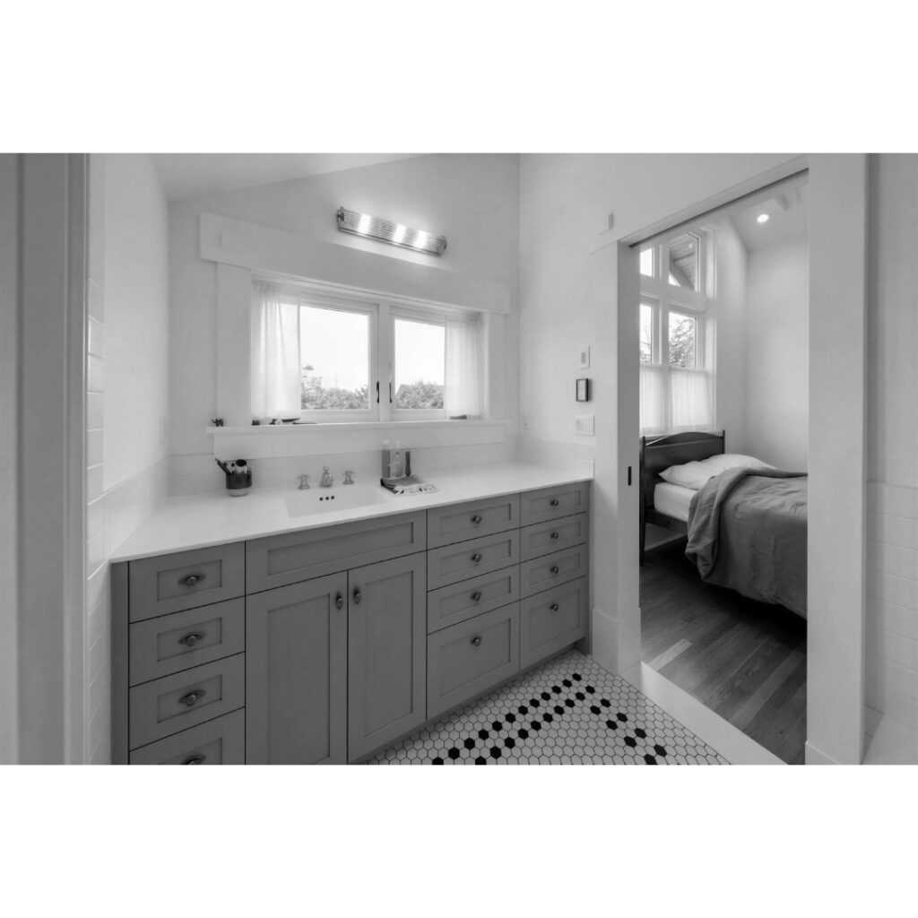 Primary Suite in Seattle Craftsman residence with double height volume; vanity cabinet with view toward the mountains